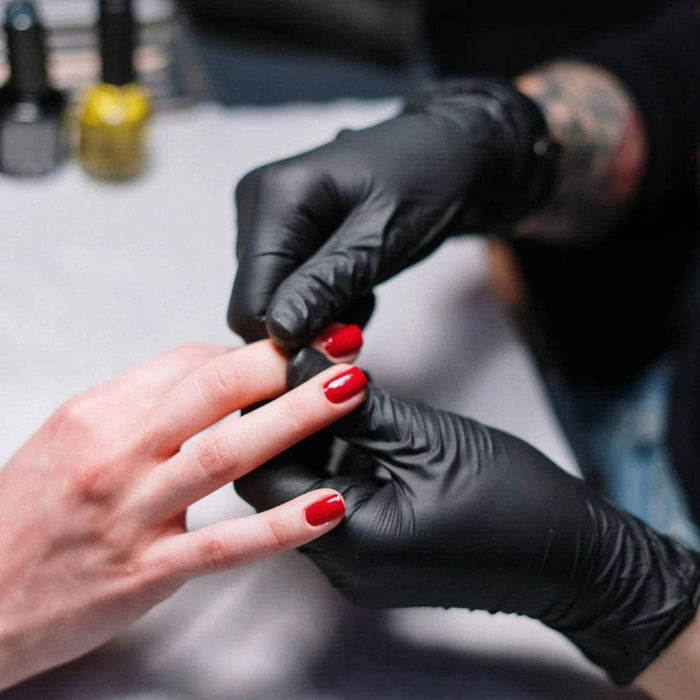 Beautician Wearing GP Craft 5.5 MIL Black Nitrile Exam Gloves While Providing Manicures